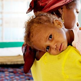 When Farida brought her one-year-old daughter to this Save the Children-supported, government-run facility, she thought she would die. Now the little girl in her arms has improved greatly, and is even playing with other children at the clinic. Photo Credit: Lucia Zoro/Save the Children 2011. When Farida brought her one-year-old daughter to this Save the Children-supported, government-run facility, she thought she would die. Now the little girl in her arms has improved greatly, and is even playing with other children at the clinic. Photo Credit: Lucia Zoro/Save the Children 2011.