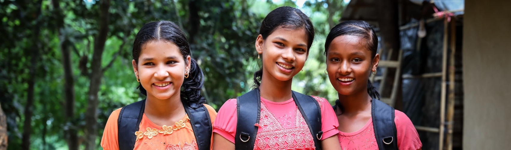 3 school girls wearing backpacks smiling at the camera 3 school girls wearing backpacks smiling at the camera