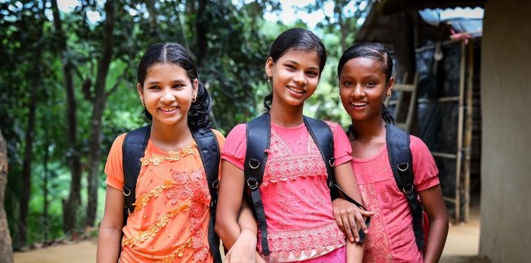 Three girls with school bags Three girls with school bags
