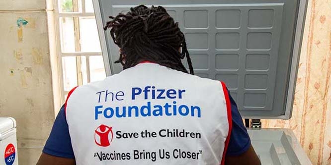 Save the Children worker unpacking vaccines from Pfizer in Kenya Save the Children worker unpacking vaccines from Pfizer in Kenya