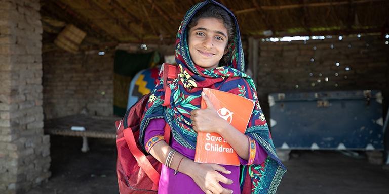 Pakistan, a little girl stands in front of a Temporary Learning Centre TLC in her village to ensure children can continue their education after the village school was flooded and destroyed. Pakistan, a little girl stands in front of a Temporary Learning Centre TLC in her village to ensure children can continue their education after the village school was flooded and destroyed.