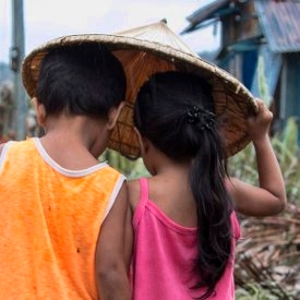 A boy of four and a girl of three walk through their village in Dolores, Eastern Samar, Philippines, after Typhoon Hagupit tore through the region, leaving many with destroyed homes and without bare essentials. Photo Credit: Jonathan Hyams/Save the Children 2014. A boy of four and a girl of three walk through their village in Dolores, Eastern Samar, Philippines, after Typhoon Hagupit tore through the region, leaving many with destroyed homes and without bare essentials. Photo Credit: Jonathan Hyams/Save the Children 2014.