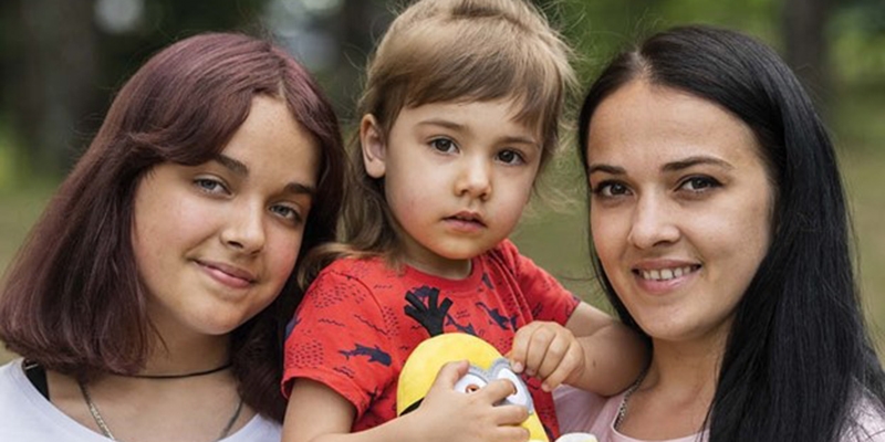 Ukraine, a family of 3 smile at the camera. Ukraine, a family of 3 smile at the camera.