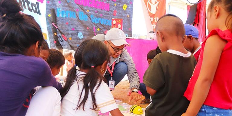 A staff member works with kids at a Save the Children program A staff member works with kids at a Save the Children program