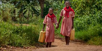 Two young girls fetch water together in Uganda. Photo Credit: Rick D'Elia/Save the Children 2016 Two young girls fetch water together in Uganda. Photo Credit: Rick D'Elia/Save the Children 2016