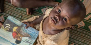 A child at a reading workshop run by Save the Children at Mahama Refugee Camp, Rwanda A child at a reading workshop run by Save the Children at Mahama Refugee Camp, Rwanda