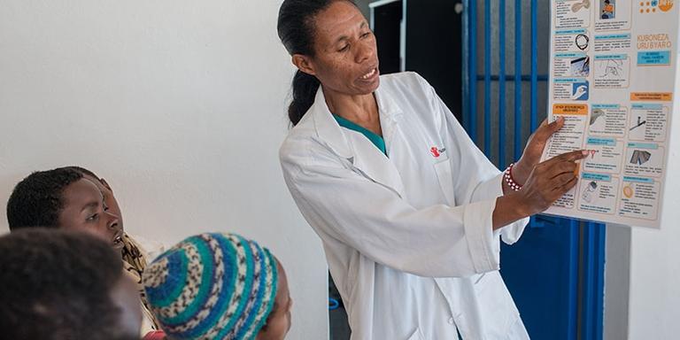 A doctor points to a chart. A doctor points to a chart.