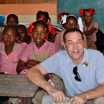 Sam Simon at a school in Haiti after the Earthquake. Photo Credit: Save the Children 2015. Sam Simon at a school in Haiti after the Earthquake. Photo Credit: Save the Children 2015.