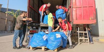 A truck filled with humanitarian aid for Gaza gets filled by Save the Children staffers. A truck filled with humanitarian aid for Gaza gets filled by Save the Children staffers.