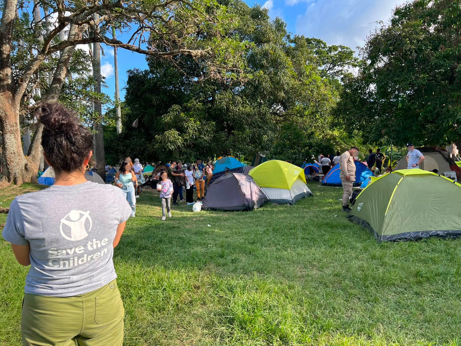 Save the Children staff visit a park where families are camping