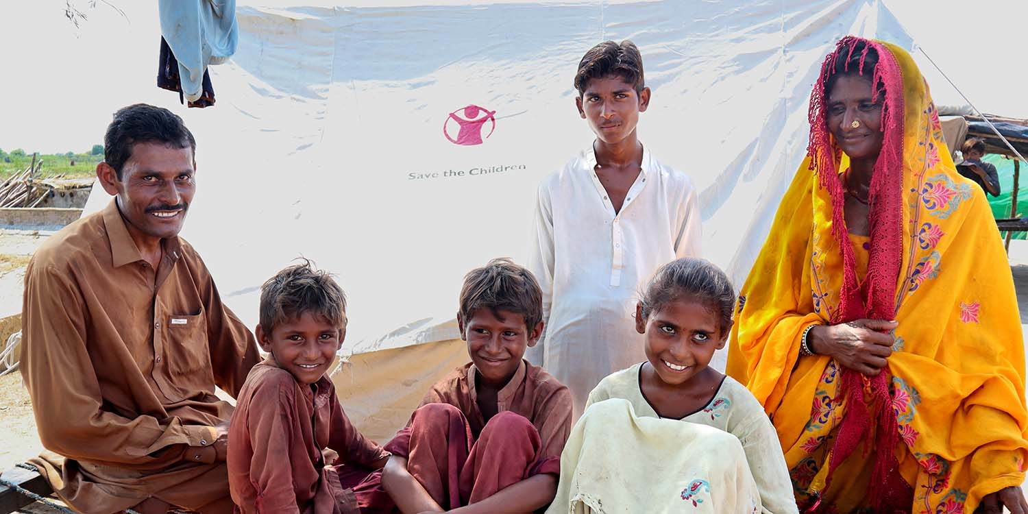 Pakistan, a family smiles at the camera Pakistan, a family smiles at the camera