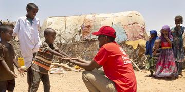 A Save the Children staff member visits children in a village in Somalia where drought has devastated crops and forced many families to be displaced. More than 1.5 million people have become internally displaced in Somalia since November 2016 as a result of drought, conflict and flooding. Photo credit: Marieke van der Velden / Save the Children, April 2019. A Save the Children staff member visits children in a village in Somalia where drought has devastated crops and forced many families to be displaced. More than 1.5 million people have become internally displaced in Somalia since November 2016 as a result of drought, conflict and flooding. Photo credit: Marieke van der Velden / Save the Children, April 2019.