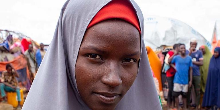 Somalia, a teenage girl stands in a displacement camp Somalia, a teenage girl stands in a displacement camp