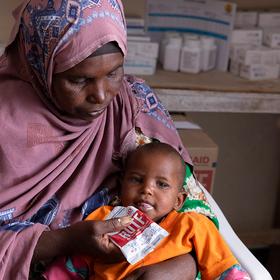 A mother feeds her malnourished son RUTF in Somalia A mother feeds her malnourished son RUTF in Somalia