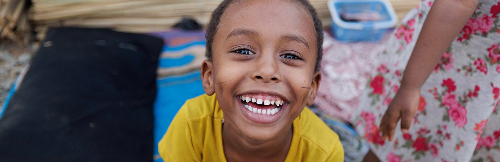 Hassan smiles at the camera in an IDP camp in South Sudan