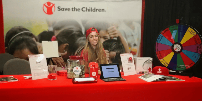 Save the Children staff member at a booth for a Stream Team event. Save the Children staff member at a booth for a Stream Team event.
