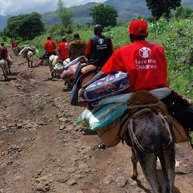 In Sudan, aid workers travel to a remote village on donkeys after a landslide. In Sudan, aid workers travel to a remote village on donkeys after a landslide.