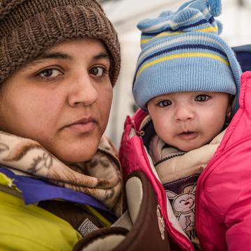 Rabia and her daughter Yasmin take shelter from the snow and freezing temperatures in a tent with their family. Photo credit: Jonathan Hyams/Save the Children, January 2016. Rabia and her daughter Yasmin take shelter from the snow and freezing temperatures in a tent with their family. Photo credit: Jonathan Hyams/Save the Children, January 2016.