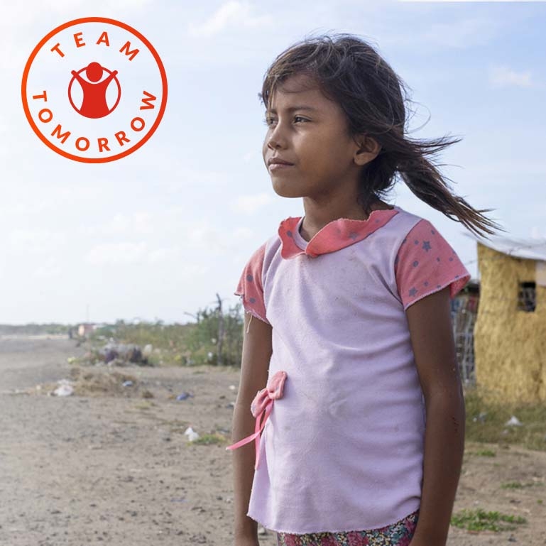 In Cambodia, a young girl stands near the shoreline where debris has washed up. In Cambodia, a young girl stands near the shoreline where debris has washed up.