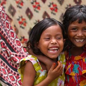 Three young girls pose for a photograph. Three young girls pose for a photograph.