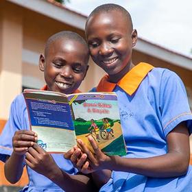 Uganda, Sarah, 13, reads a book with her little sister. Uganda, Sarah, 13, reads a book with her little sister.