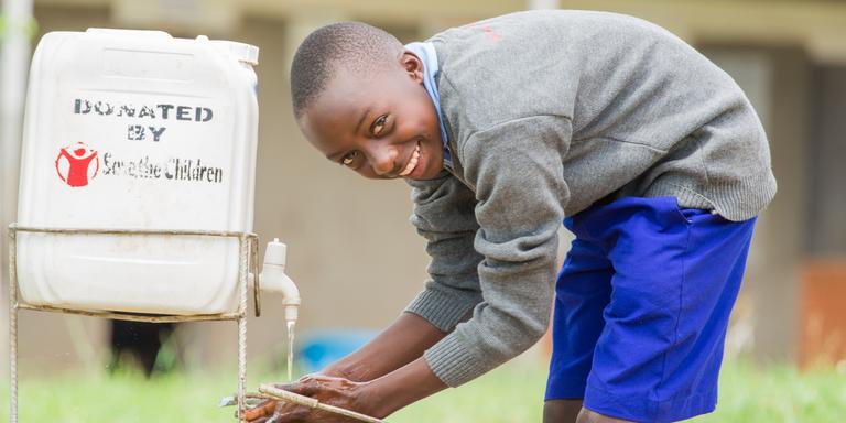 A young boy student utilizing a handwashing facility provided by Save the Children to his school. A young boy student utilizing a handwashing facility provided by Save the Children to his school.