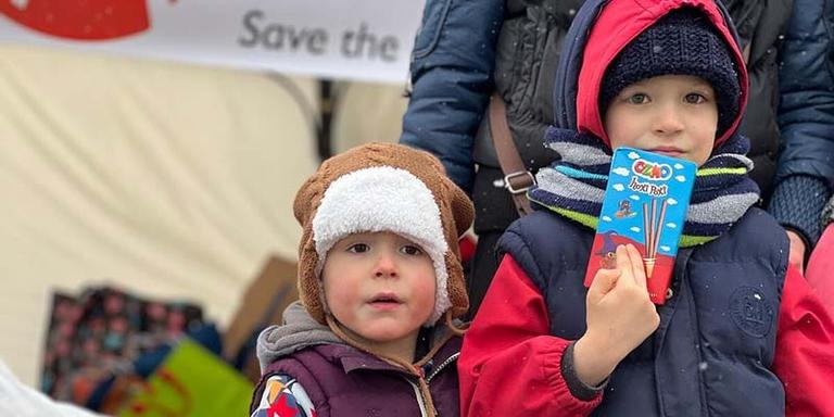 Two refugee children who have fled conflict in Ukraine receive emergency supplies after crossing the border. Two refugee children who have fled conflict in Ukraine receive emergency supplies after crossing the border.