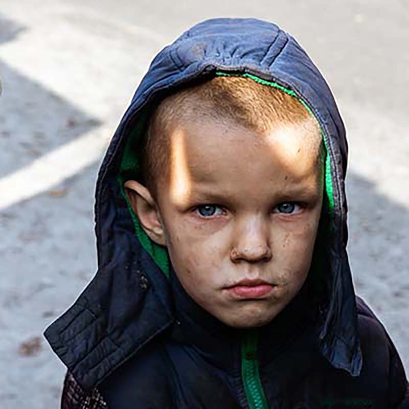 Ukraine, a young boy, stands near his house in Kyiv after a blast. Ukraine, a young boy, stands near his house in Kyiv after a blast.
