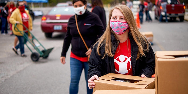 A Save the Children worker hands out supplies A Save the Children worker hands out supplies