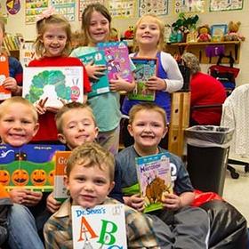 A group of first grade students hold up favorite books in their classroom in Kentucky. A group of first grade students hold up favorite books in their classroom in Kentucky.