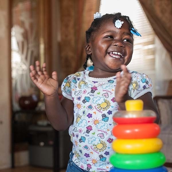 A girl smiles while playing. A girl smiles while playing.