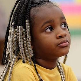 A young girl sits pensively at a desk in a classroom in Tennessee. A young girl sits pensively at a desk in a classroom in Tennessee.