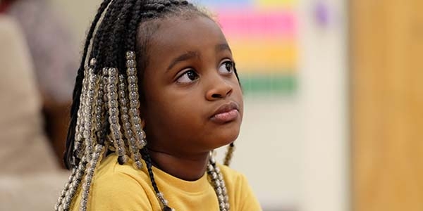 A young girl sits pensively at a desk in a classroom in Tennessee. A young girl sits pensively at a desk in a classroom in Tennessee.