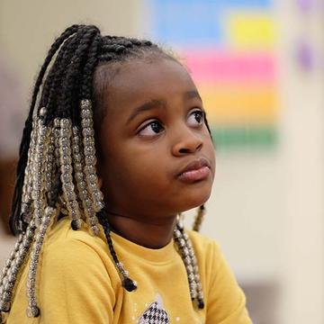 A 5-year old girl who is enrolled in Save the Children's Emergent Reader program at her school in Tennessee sits pensively in her classroom. Photo credit: Shawn Millsaps / Save the Children 2019. A 5-year old girl who is enrolled in Save the Children's Emergent Reader program at her school in Tennessee sits pensively in her classroom. Photo credit: Shawn Millsaps / Save the Children 2019.