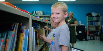 Tennessee, 7-year-old Corbin picks out a book to read in the library at his school. Tennessee, 7-year-old Corbin picks out a book to read in the library at his school.