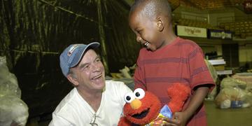A three-year-old shares a moment of fun with Save the Children's emergency response specialist, Dudley Conneely, at a center Baton Rouge, Louisiana. Save the Children set up child-friendly places to help children recovering from Hurricane Katrina have a safe place to play and recover, while their parents work to rebuild their lives. Photo Credit: Jim Loring/Save the Children 2005. A three-year-old shares a moment of fun with Save the Children's emergency response specialist, Dudley Conneely, at a center Baton Rouge, Louisiana. Save the Children set up child-friendly places to help children recovering from Hurricane Katrina have a safe place to play and recover, while their parents work to rebuild their lives. Photo Credit: Jim Loring/Save the Children 2005.