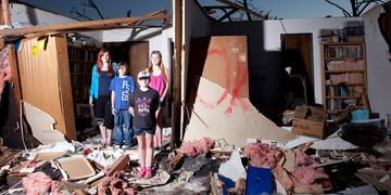 A group of children stands amid the debris that was once their grandmother’s home after an EF5 tornado hit Moore, Oklahoma in May of 2013. A group of children stands amid the debris that was once their grandmother’s home after an EF5 tornado hit Moore, Oklahoma in May of 2013.