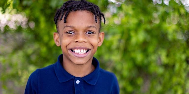 A boy looks at the camera and smiles. A boy looks at the camera and smiles.