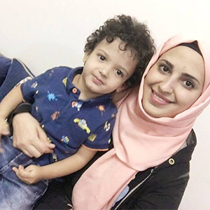 A mother holding her young son on her lap. A mother holding her young son on her lap.