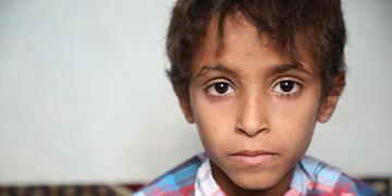 An eight-year old boy is pictured sitting inside a home in Yemen. The boy was on a school bus riding through Saada, Yemen, when the bus was bombed. 40 children under the age of 10 were killed. He survived but not without significant injuries. He had shrapnel fragments next to his eye, in his leg and in his little toe. His foot was broken. Save the Children helped provide the boy with medical care and now, his physical injuries have healed. Since May 2015, through donor support, Save the Children has reached An eight-year old boy is pictured sitting inside a home in Yemen. The boy was on a school bus riding through Saada, Yemen, when the bus was bombed. 40 children under the age of 10 were killed. He survived but not without significant injuries. He had shrapnel fragments next to his eye, in his leg and in his little toe. His foot was broken. Save the Children helped provide the boy with medical care and now, his physical injuries have healed. Since May 2015, through donor support, Save the Children has reached
