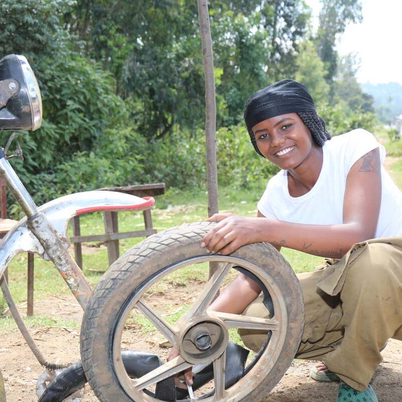 A girl holds a tire to demonstrate the skills she learned through Save the Children's Young Women's Leadership & Economics Empowerment Program (LEEP) in Ethiopia. A girl holds a tire to demonstrate the skills she learned through Save the Children's Young Women's Leadership & Economics Empowerment Program (LEEP) in Ethiopia.