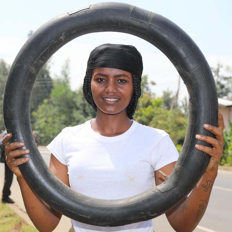 A girl holds a tire to demonstrate the skills she learned through Save the Children's Young Women's Leadership & Economics Empowerment Program (LEEP) in Ethiopia. A girl holds a tire to demonstrate the skills she learned through Save the Children's Young Women's Leadership & Economics Empowerment Program (LEEP) in Ethiopia.